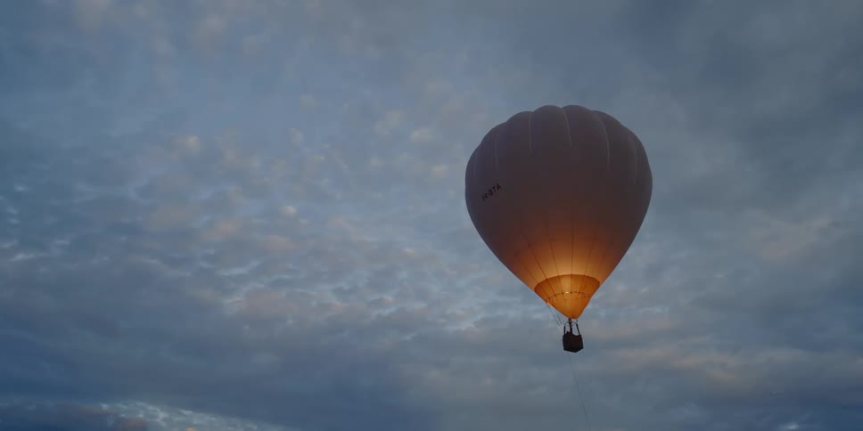 A hot air balloon floats through the sky