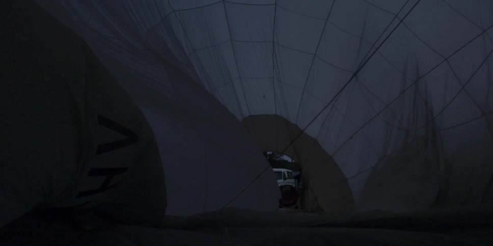 Interior of inflating hot air balloon reveals view of vehicle