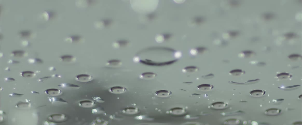 Water drops fall from a metal surface