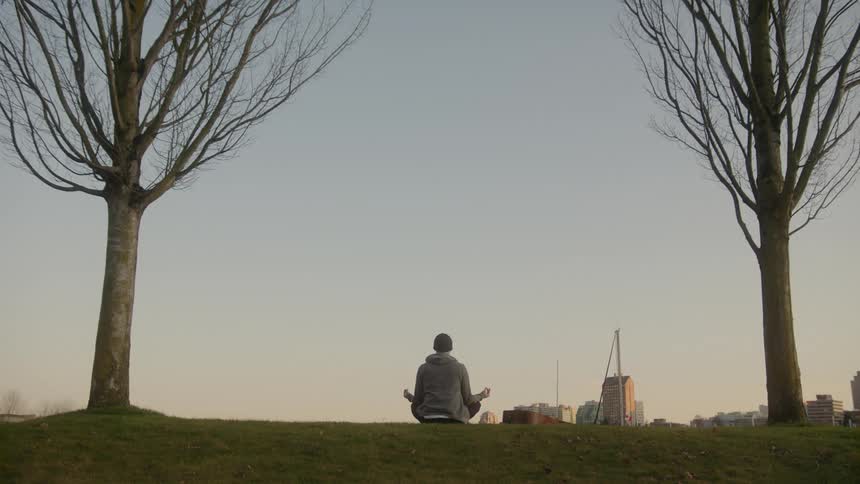 A person poses to meditate