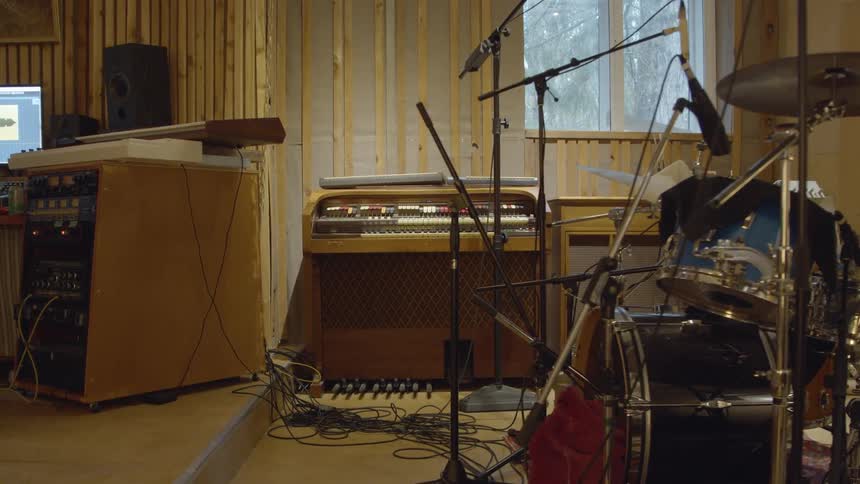 Musical instruments and recording equipment occupy room near window