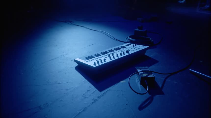Electronics equipment sits on the floor as a light shines on it