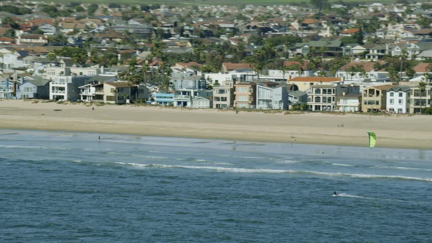 Aerial view of a kite surfer shredding near the coast