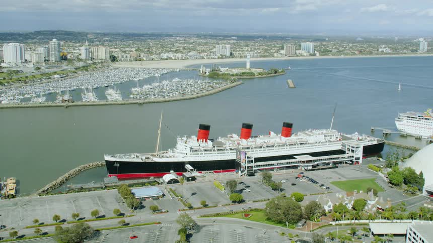 Ships are docked at port across channel from downtown city and marina