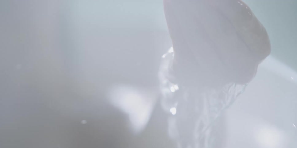 Woman washes hand with hoth water