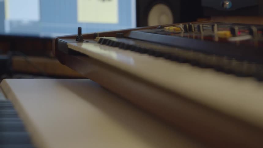 Light reflects off of the piano keyboard