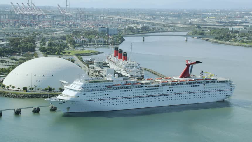 Two cruise ships are docked by the city