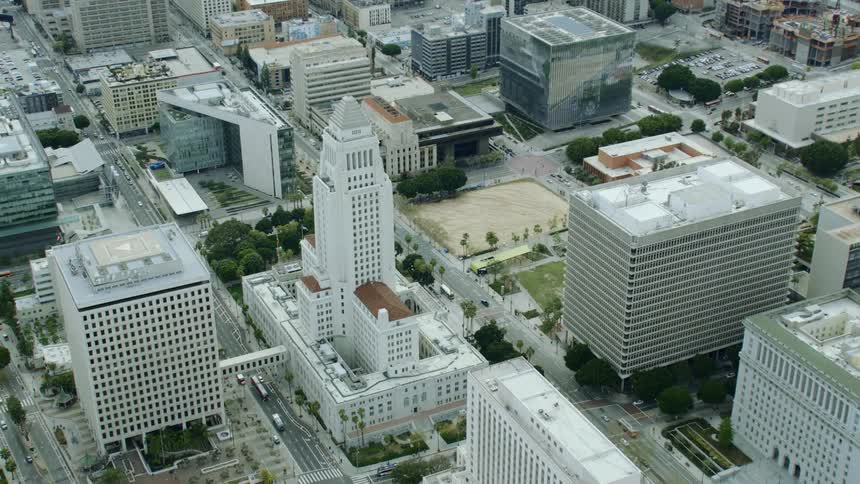 A tall building in the downtown area of city during the day