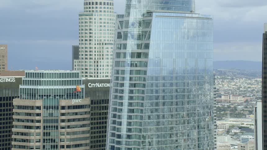 The tall buildings have signs with names at the top