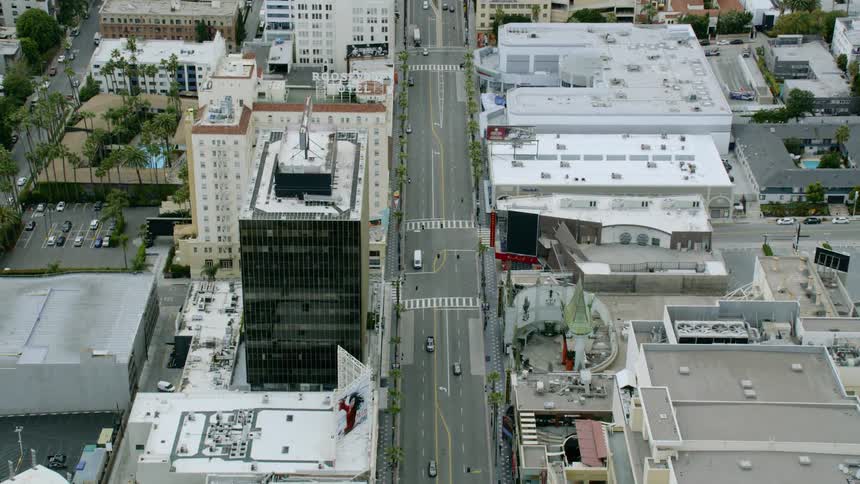 Aerial zoom out of of a city street and cars