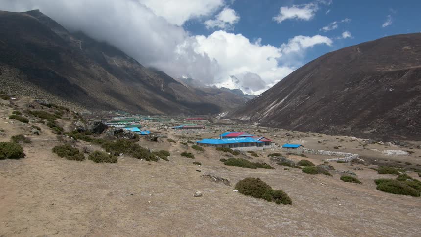 Town with colorful buildings occupies valley between mountains