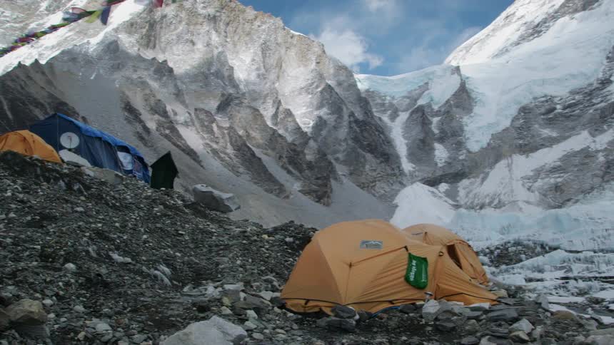 Mountain base camp in front of the snow covered mountains