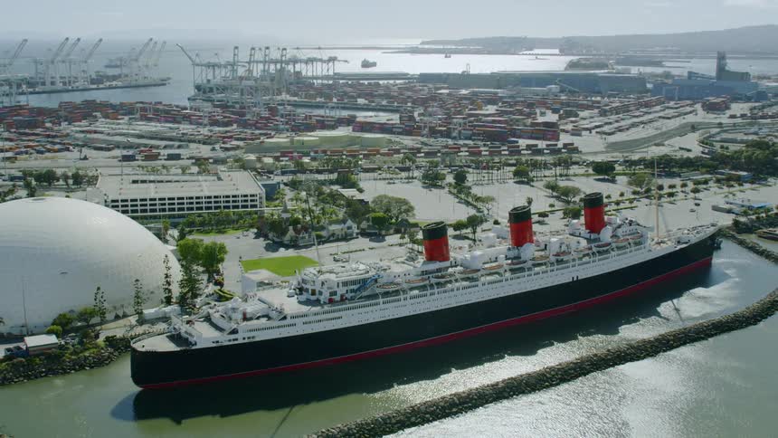 A large cruise ship sits at a port side
