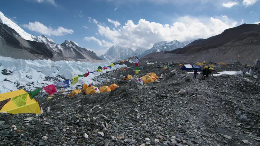 Colorful prayer flags hanging on a line in the wind at a mountain base camp
