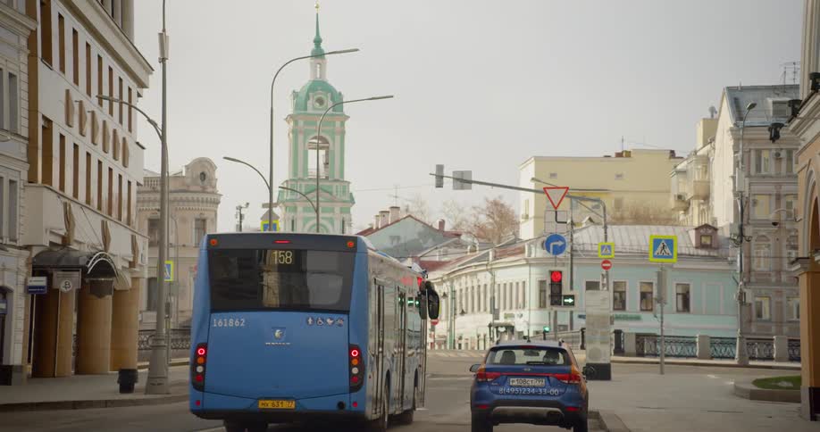 A bus travels through a city street