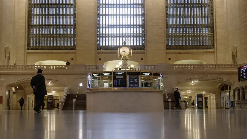 People walk through nearly empty transportation center