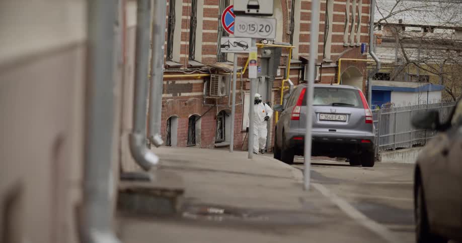 A person with a hazmat suit walking on the street
