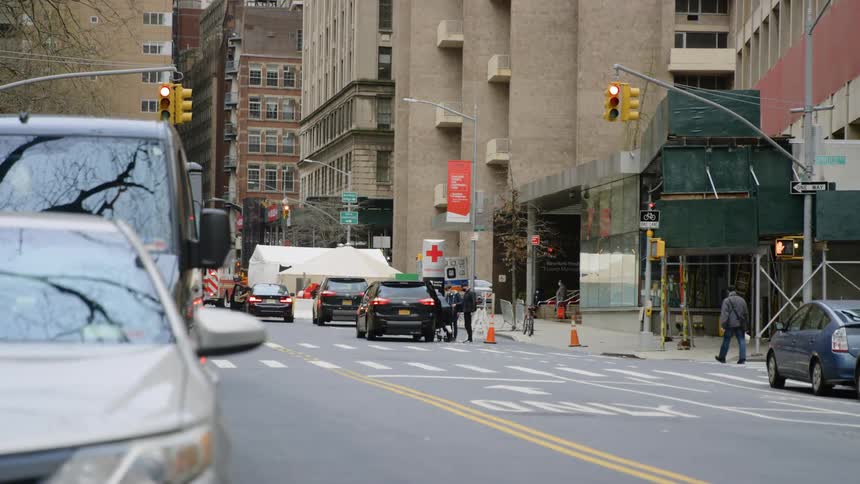 Person gets into car parked in front of hospital on city street