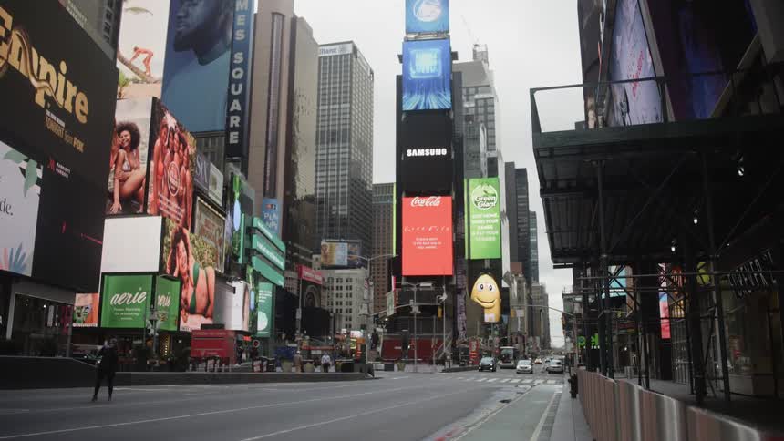 Video billboards flash and change on a city street