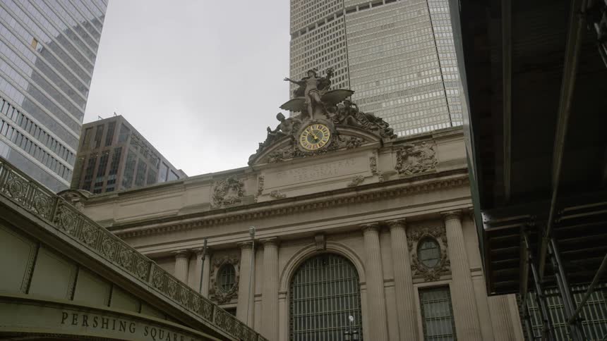 A clock sits atop a city building