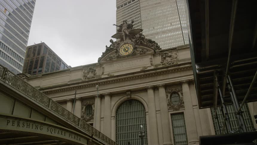 The building has a clock and statue at the top