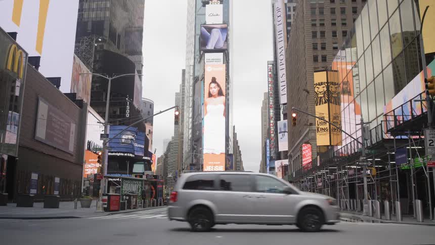Cars drive past the intersection in times square