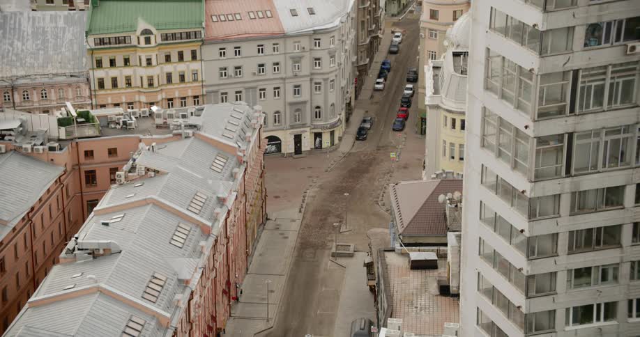 A city neighborhood with roads and vehicles