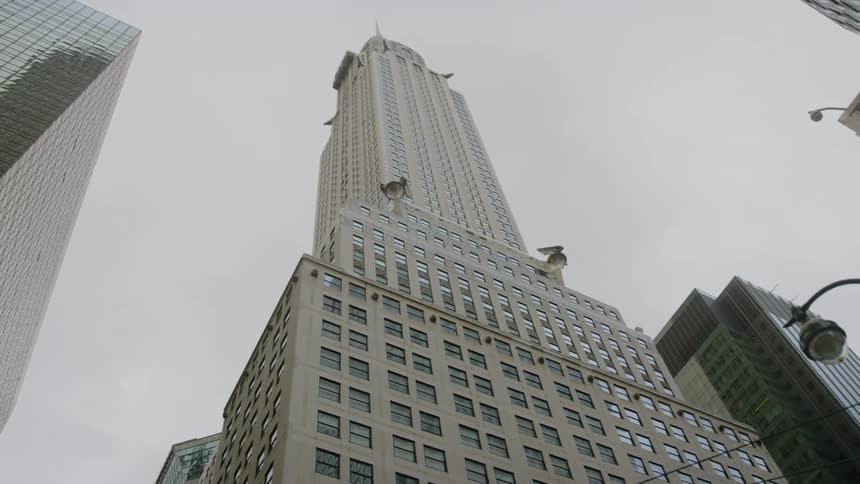 Skyscrapers tower over streetlight on a cloudy day