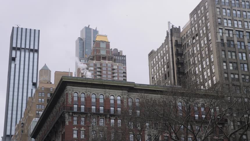 Steam coming off the roof of a building in city downtown