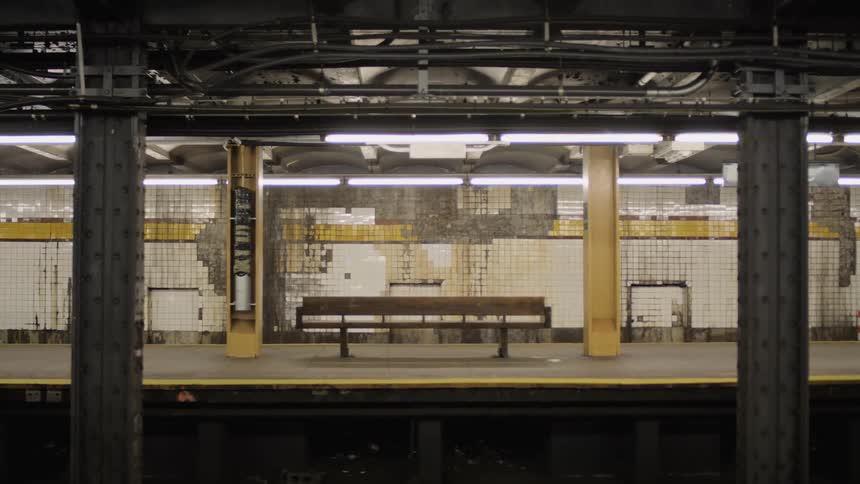 An empty bench sits on a train platform