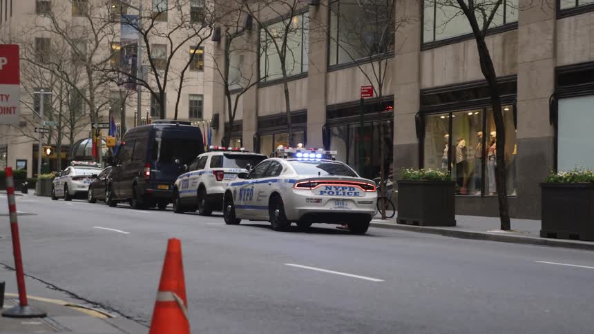 The cop cars are parked on the street
