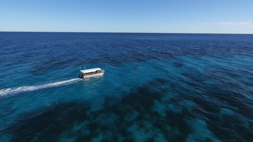 A boat in the ocean on a sunny day