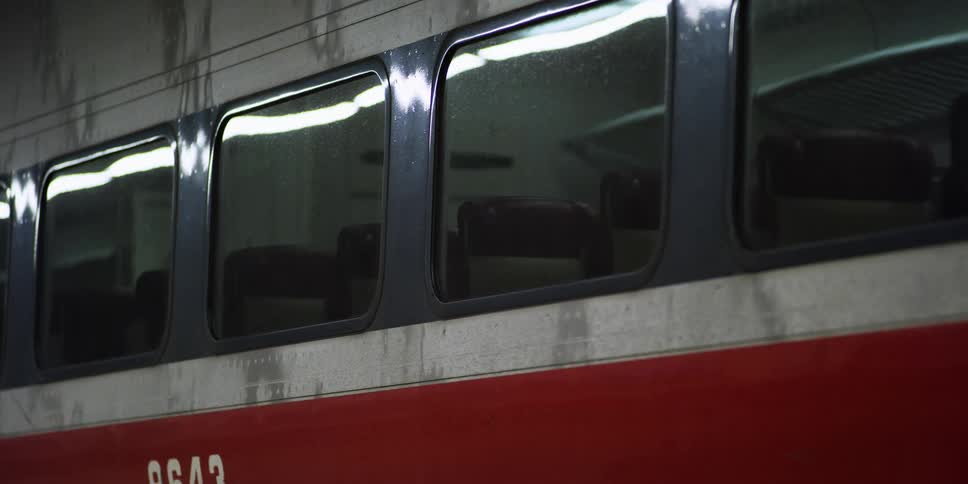 A train with windows with light reflecting off of it