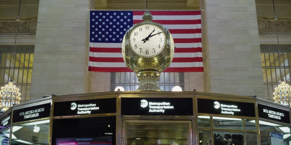 A clock sits on to of an information booth at the metropolitan transportation authority