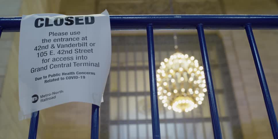 A sign is posted on a gate stating an entrance is closed