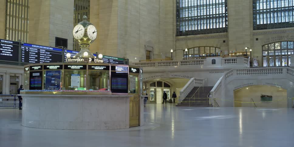 A few people walk in the station