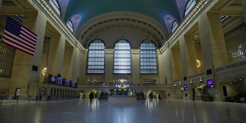 A few people stand inside a large building