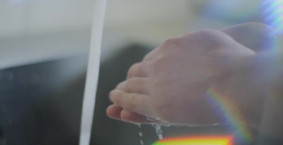 A person is washing their hands with soap and water