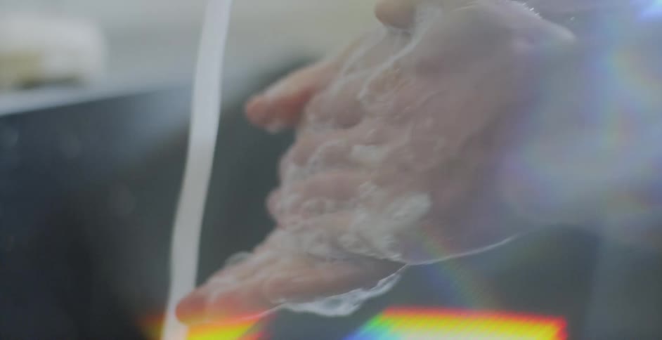 A person washes their hands