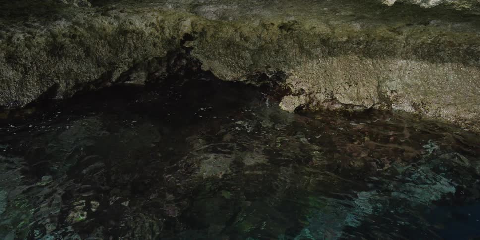 Calm translucent waters rubbing on rocky bed