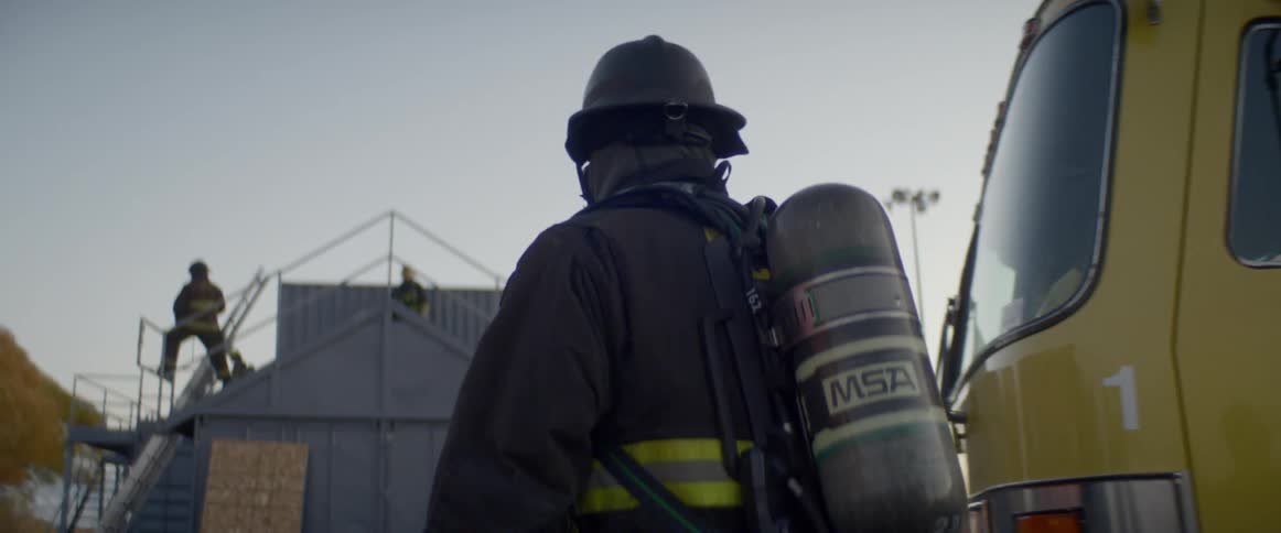 Firefighters work on the scene of accident at dusk