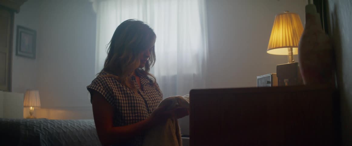 A young girls smells an article of clothing