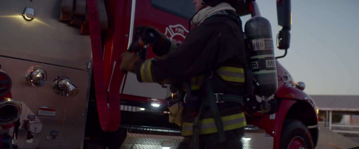 Firefighter works on the scene of accident at dusk