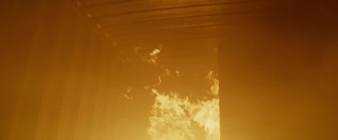 A fire burns inside a metal container