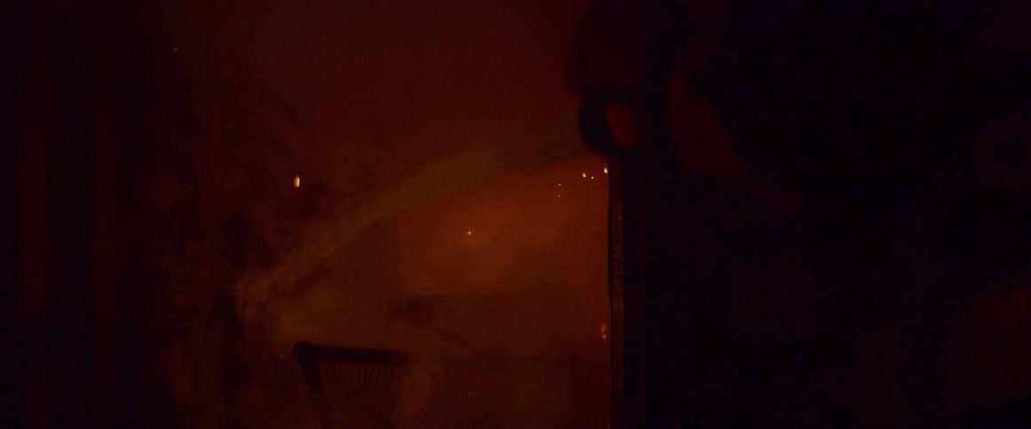 A firefighter sprays water on a fire