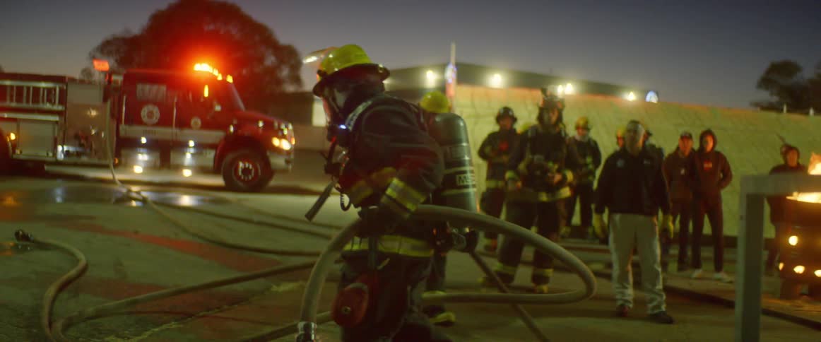 Firefighters work on the scene of accident at dusk