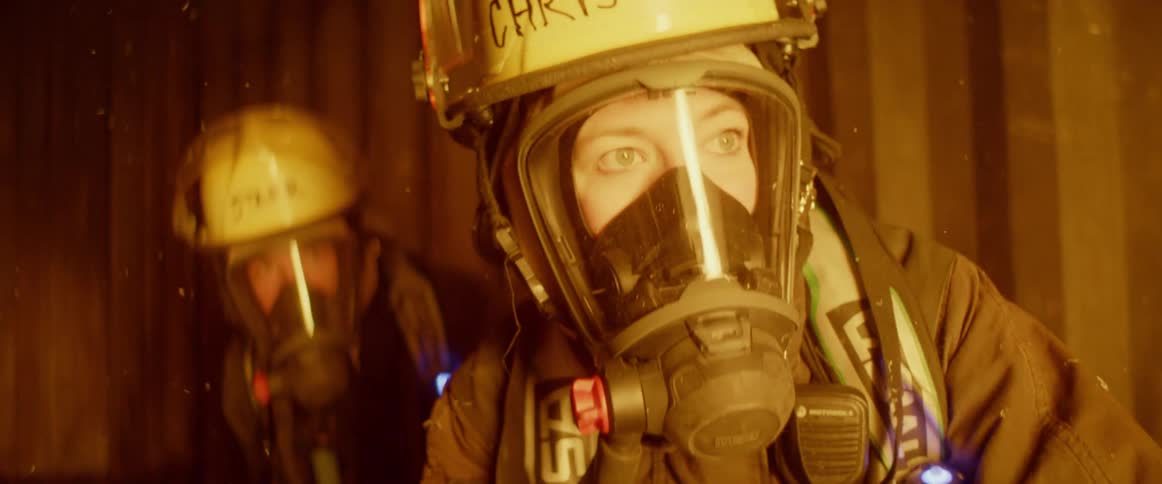 Firefighters carefully observing fire indoors before taking action