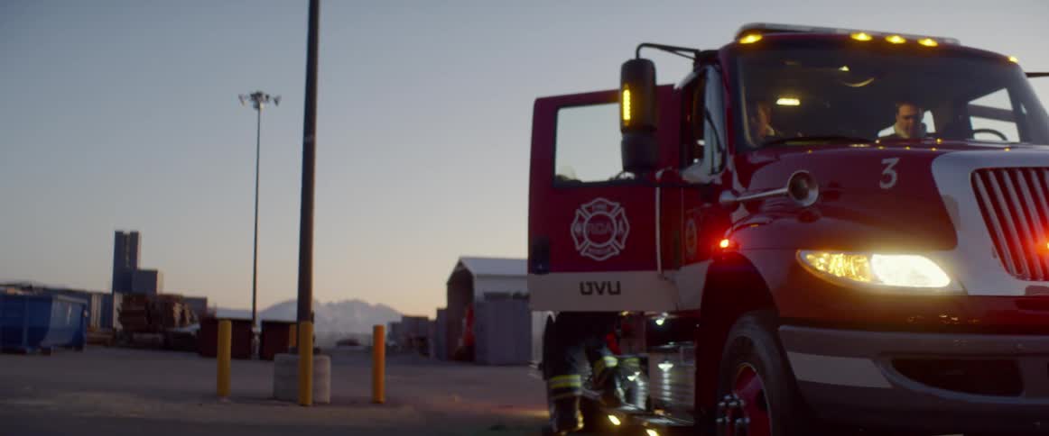 A fireman gets out of a fire truck