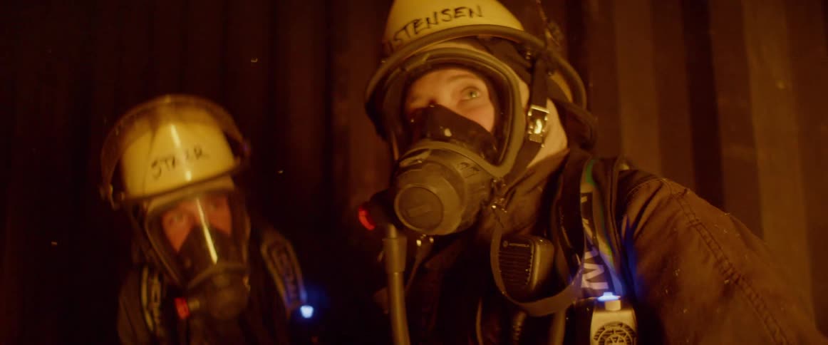 Two female firefighters sit and talk