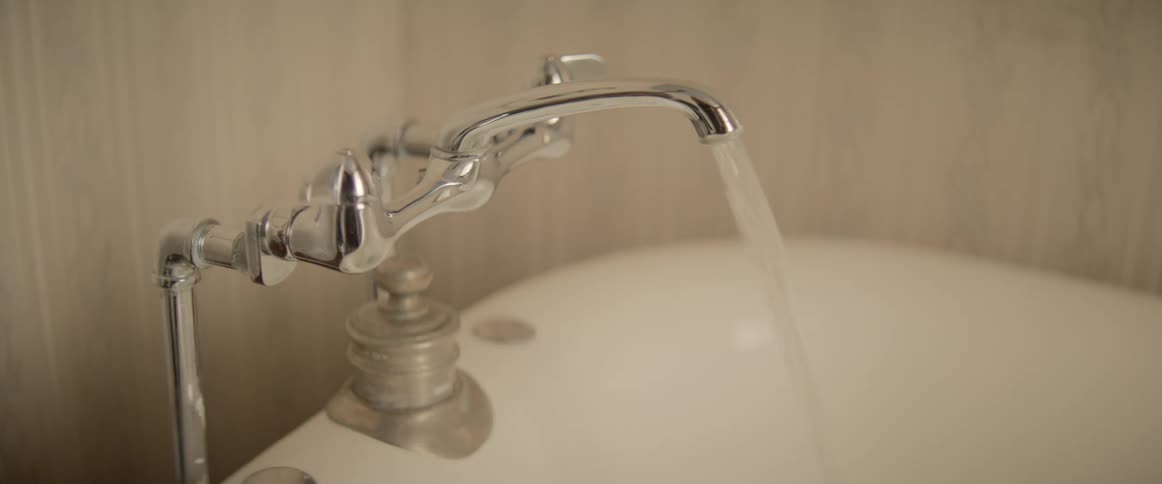 Water runs out of a faucet
